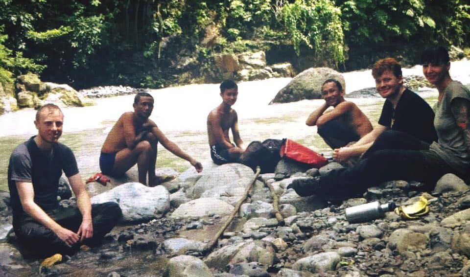 Happy campers taking a break beside the river.