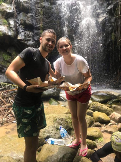 Enjoying lunch by a jungle waterfall.