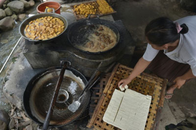 Locally made tofu and tempe for sale in the market.Making Tofu