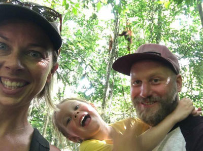 Family selfie with a wild orangutan