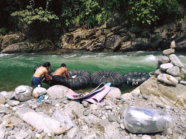 Preparing the inner tube raft to return to the village after a trek